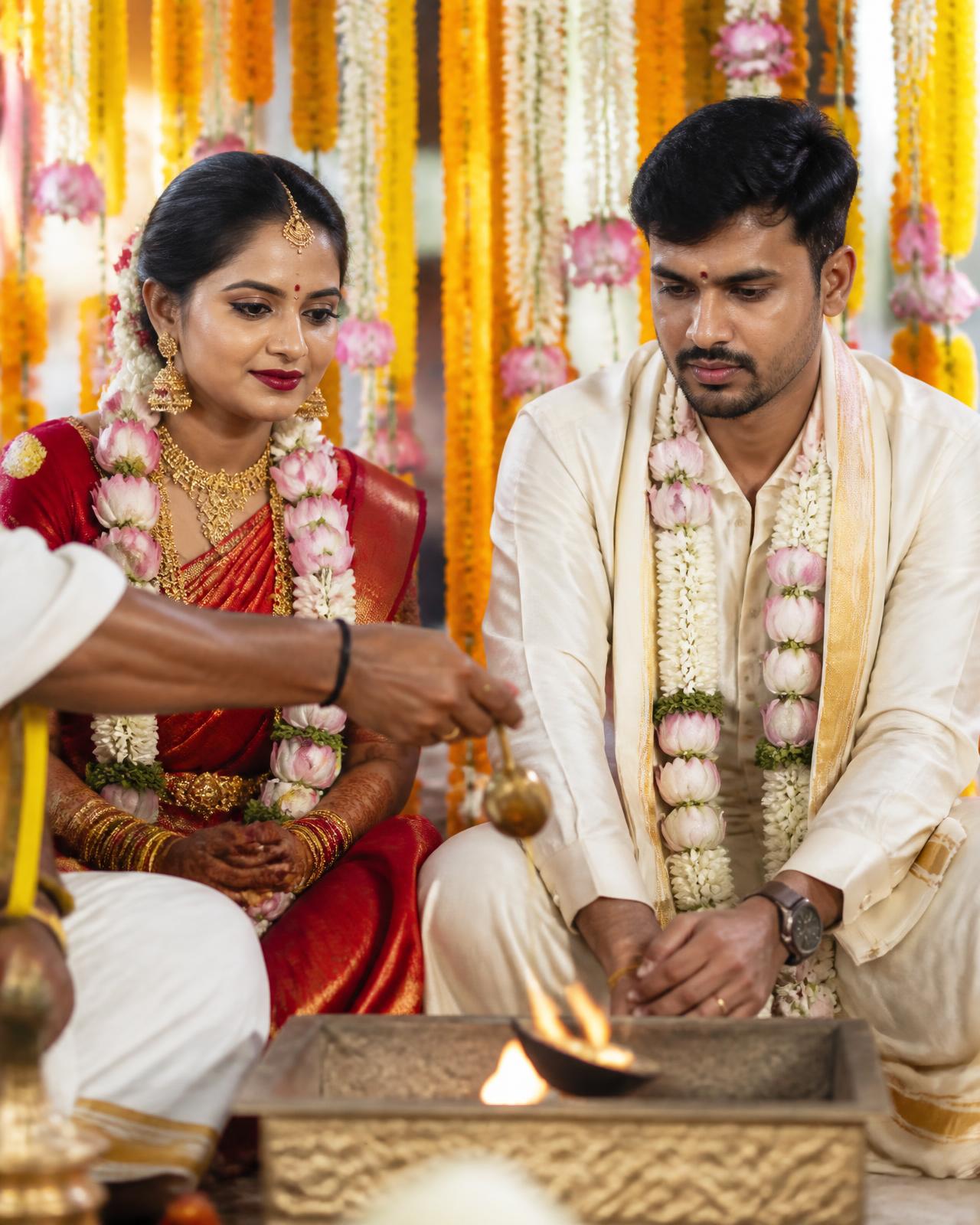 A South Indian bride and groom seated before the sacred fire during the muhurtham